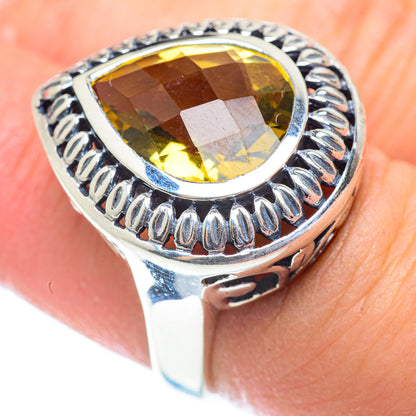 Oval citrine ring with faceted yellow stone and engraved sterling silver band, size 6.25