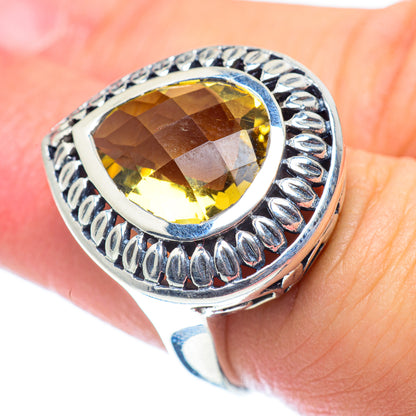 Citrine gemstone ring with large faceted yellow stone and ornate silver bezel