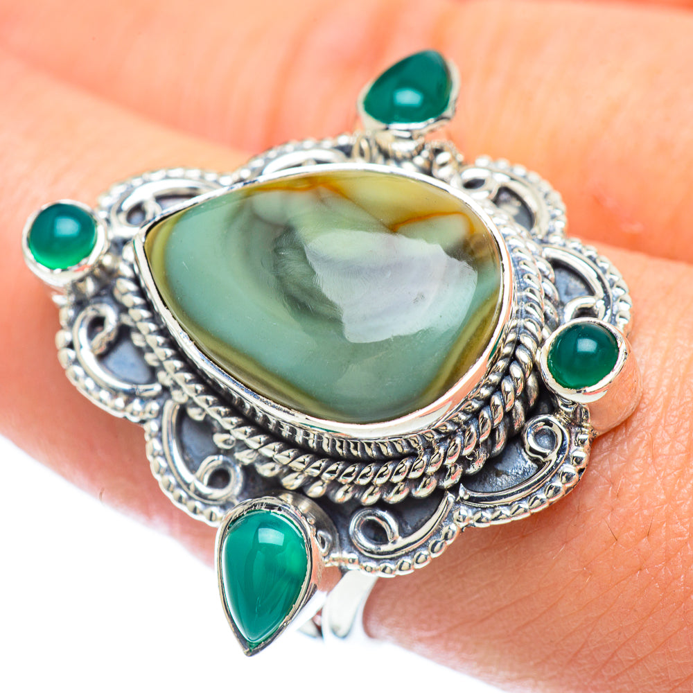 Sterling silver ring with oval green center stone and four teal accents