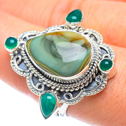 Sterling silver ring with oval green center stone and four teal accents