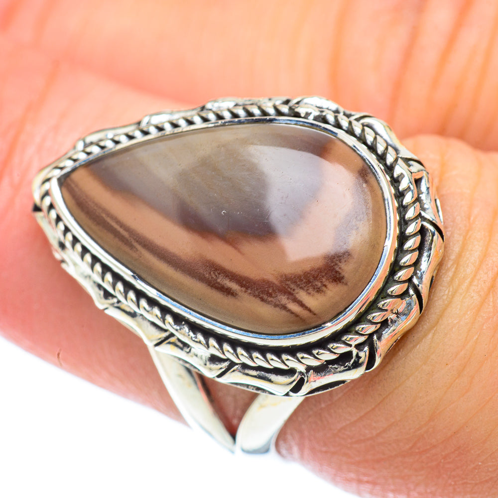 Sterling silver oval jasper ring with rope-edged bezel and smooth band on finger