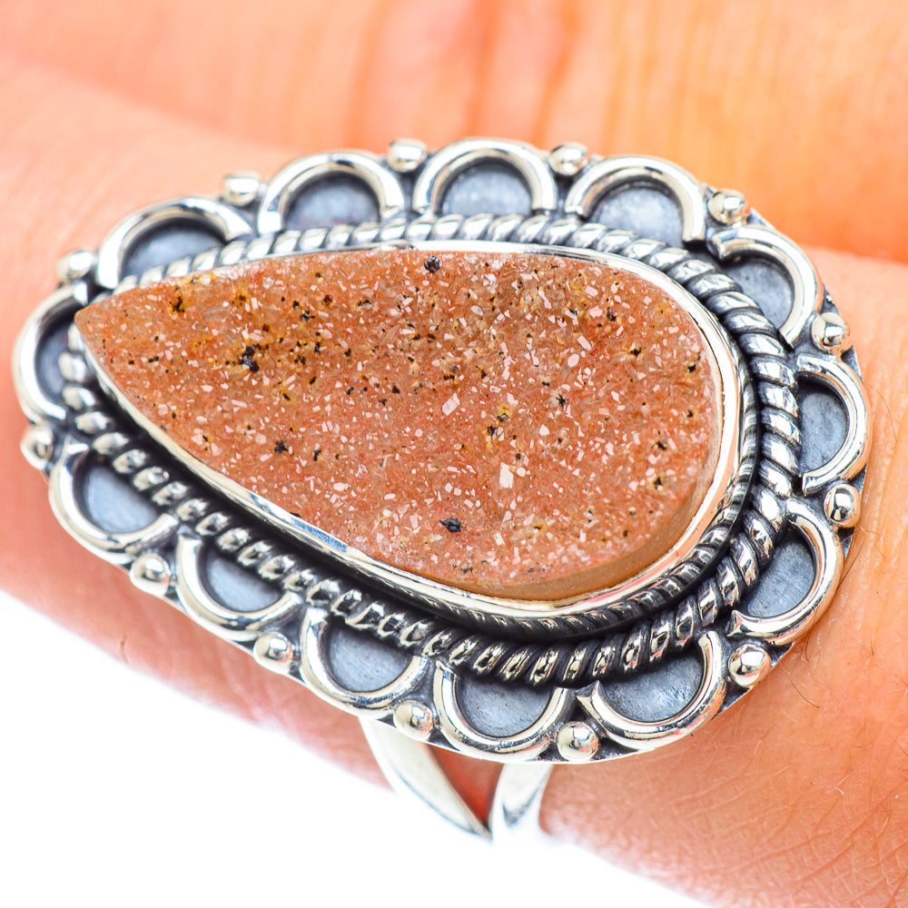 Orange druzy teardrop ring with ornate 925 sterling silver bezel and halo setting