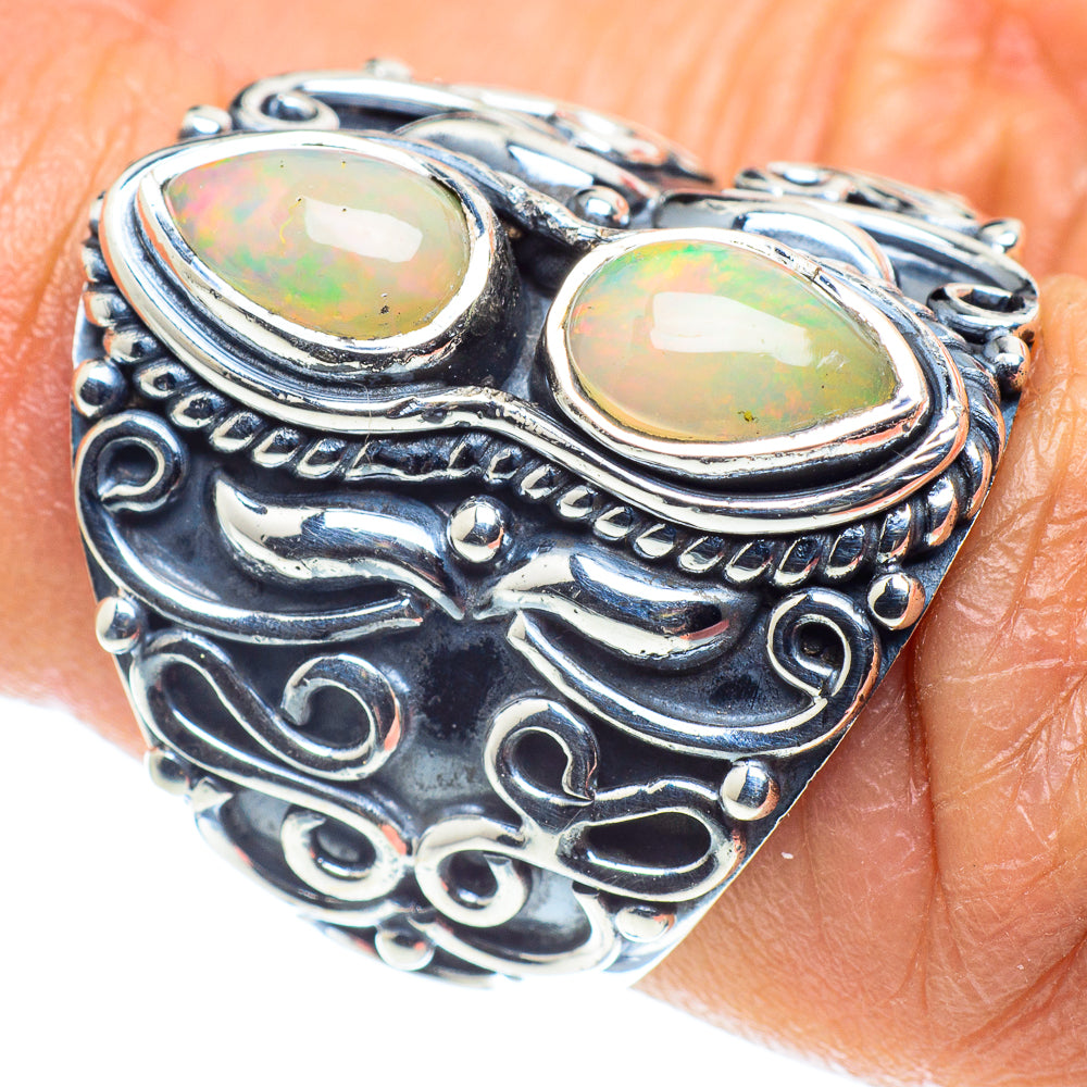 Sterling silver opal ring with two oval opal cabochons and ornate cutout band