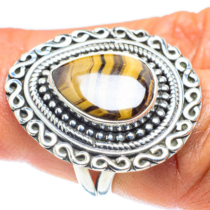 Sterling silver oval tiger eye ring with dotted bezel and scrollwork sides