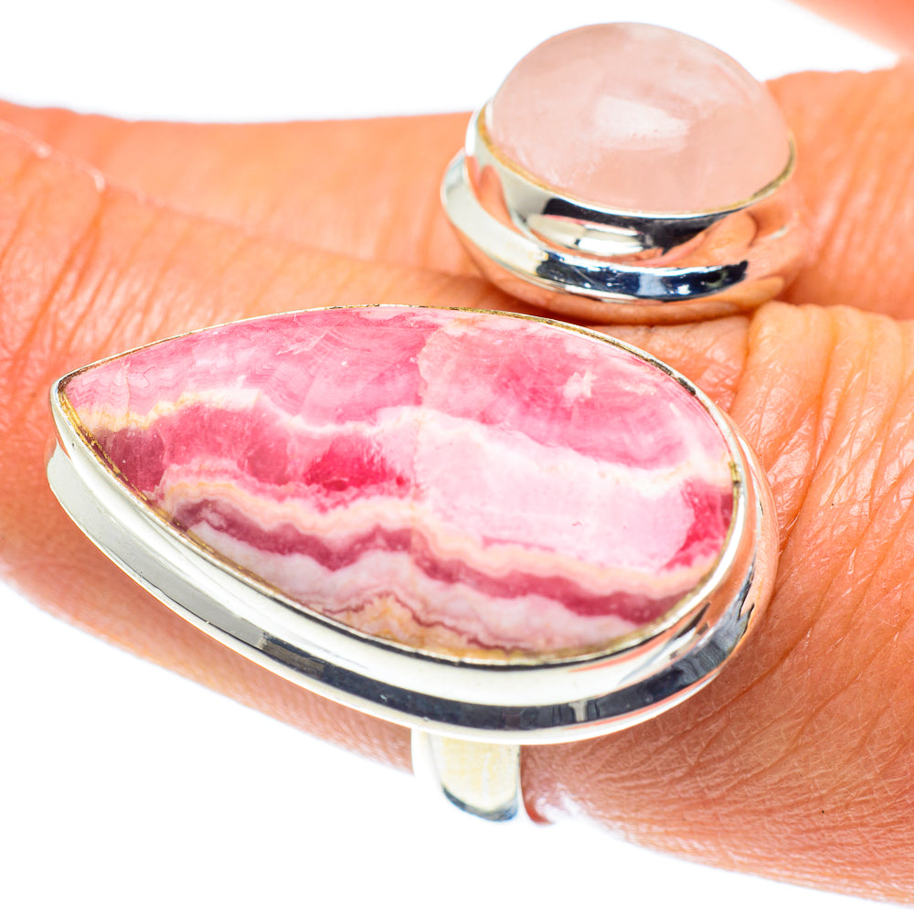 Silver ring with pink oval marbled cabochon on finger, polished band