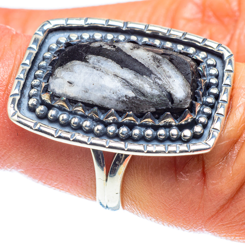Silver ring with oval dark stone and bead border bezel, faceted silver inlay