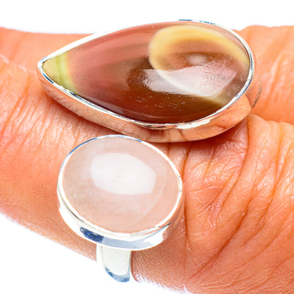 Sterling silver adjustable ring with rose quartz oval stone on finger