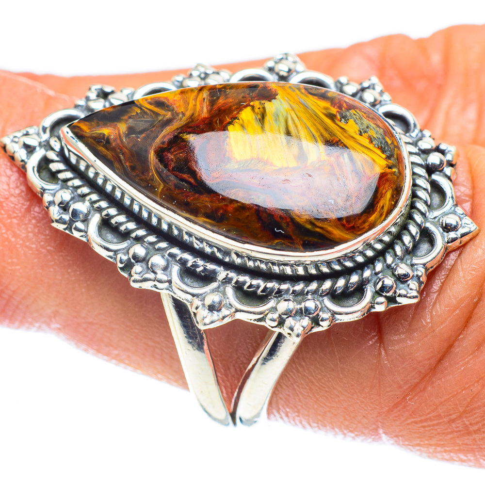 Ornate 925 silver teardrop pietersite ring with amber-gold gemstone on finger