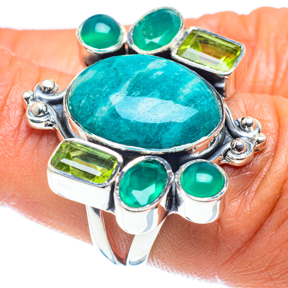 Sterling silver ring with oval turquoise-green gemstone center and green round side stones