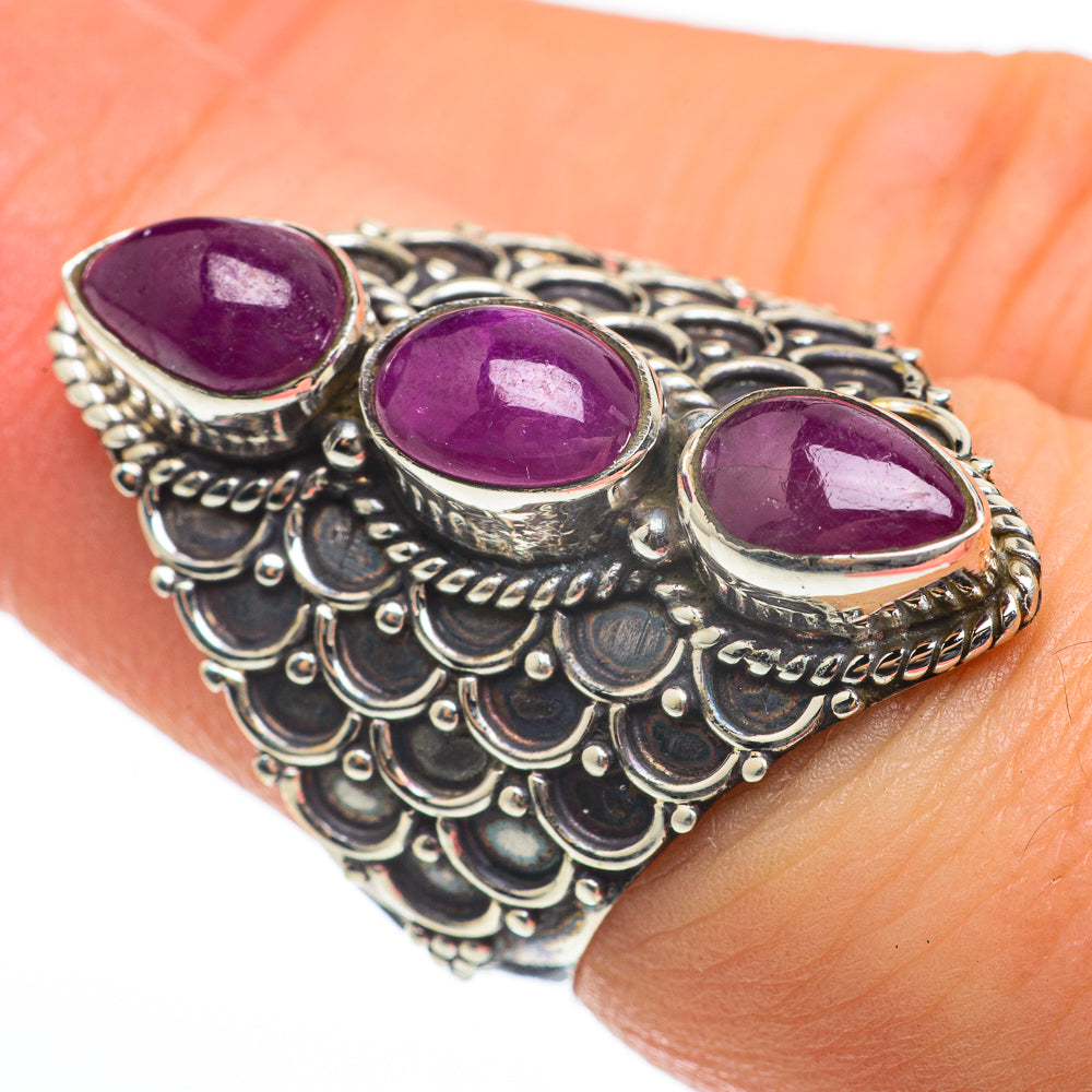 Silver ring with three oval purple gemstone cabochons and ornate scalloped band