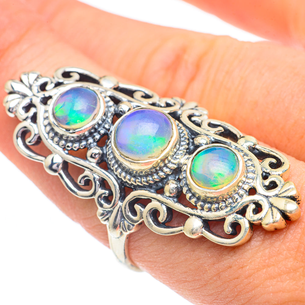 Ornate silver ring with three oval iridescent opal stones and filigree side details