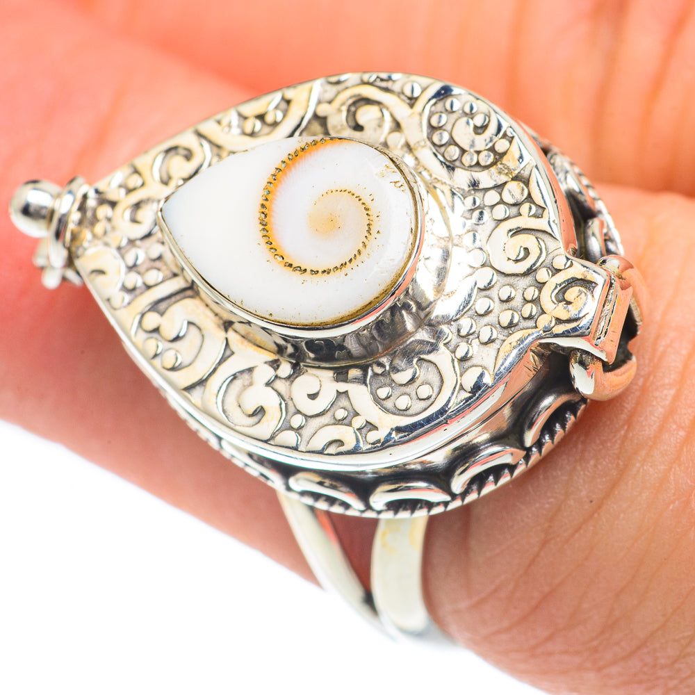 Sterling silver engraved eye ring with oval white cabochon, worn on finger