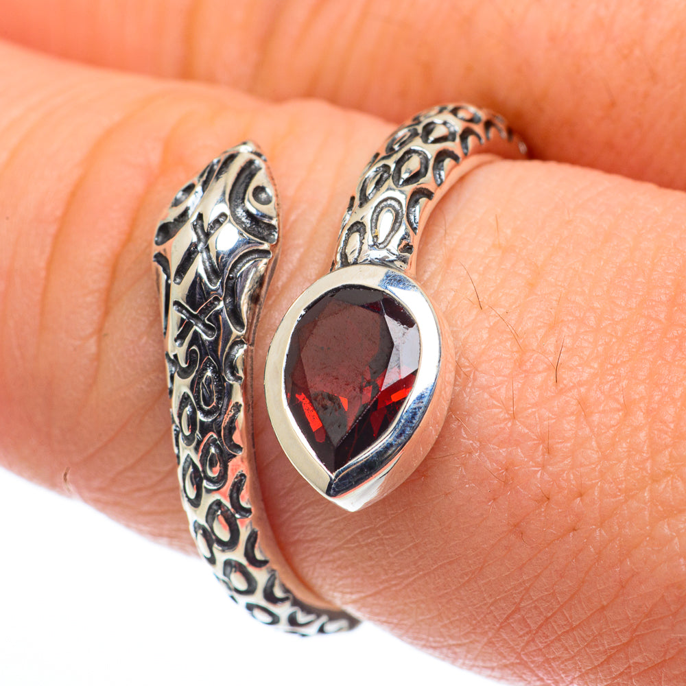 Silver adjustable ring with red teardrop garnet stone and ornate filigree band