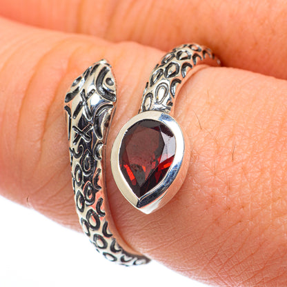 Silver adjustable ring with red teardrop garnet stone and ornate filigree band