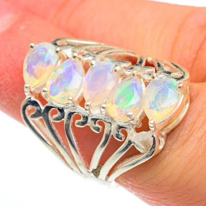 Sterling silver opal ring with three prong-set oval opal stones and ornate openwork band