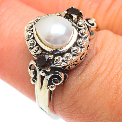 Sterling silver ring showing cultured pearl center with dark smoky quartz side accents.