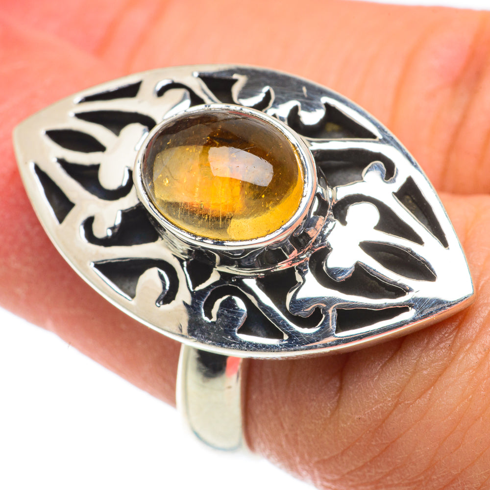Sterling silver citrine ring with oval amber gemstone and ornate cutout filigree