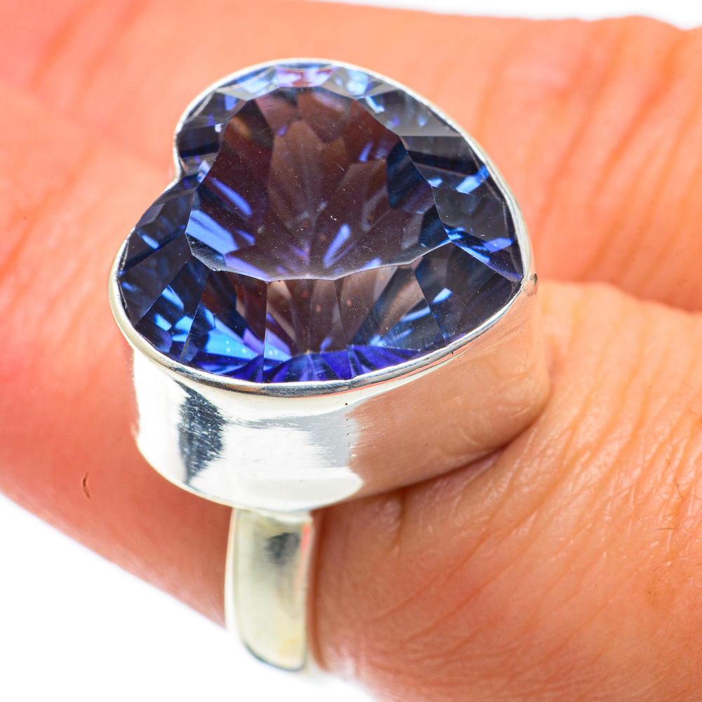 Sterling silver heart-cut blue gemstone ring on finger with polished bezel