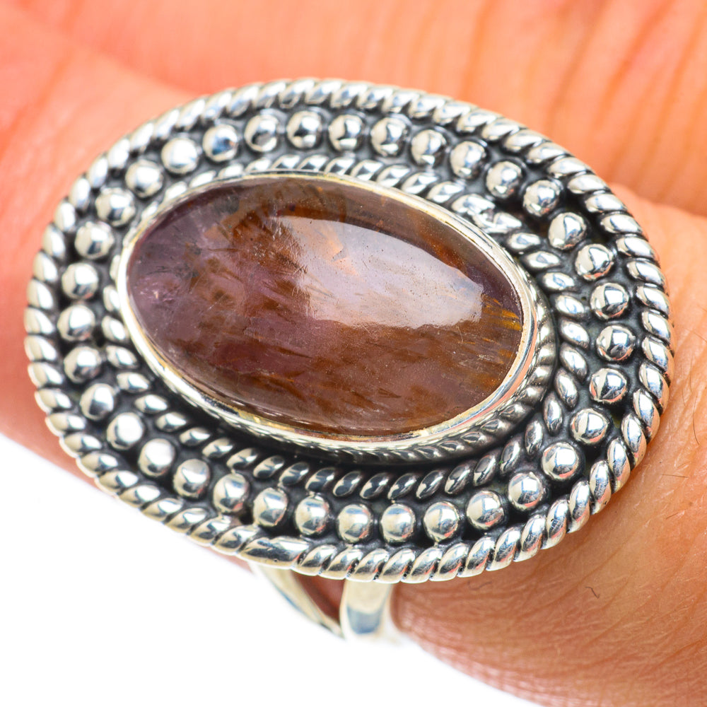 Sterling silver ring with oval brown and purple cabochon and bead-textured bezel
