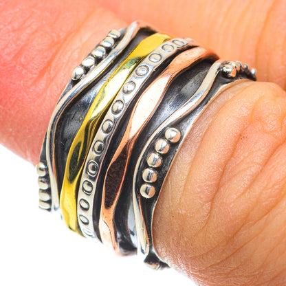 Stacked metal bands ring with copper stripe, oval row accents, and bead edge details