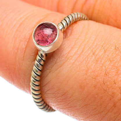 Pink tourmaline ring with twisted silver bead band and round bezel gemstone, on finger