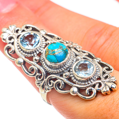 Silver-tone filigree ring with blue round stones and oval turquoise center