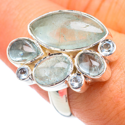 Sterling silver ring with oval aquamarine blue gemstones and round accents, adjustable fit
