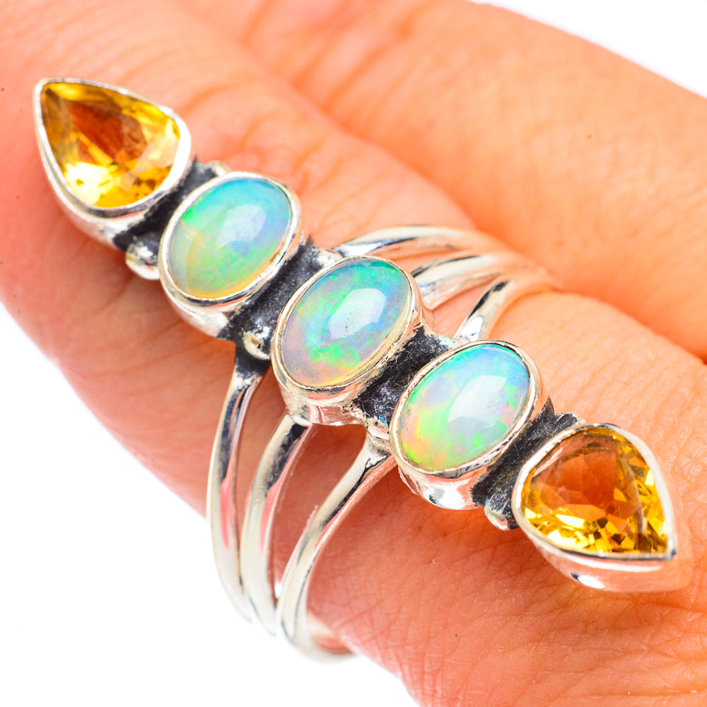 Sterling silver opal and citrine ring, close-up with oval stones on finger