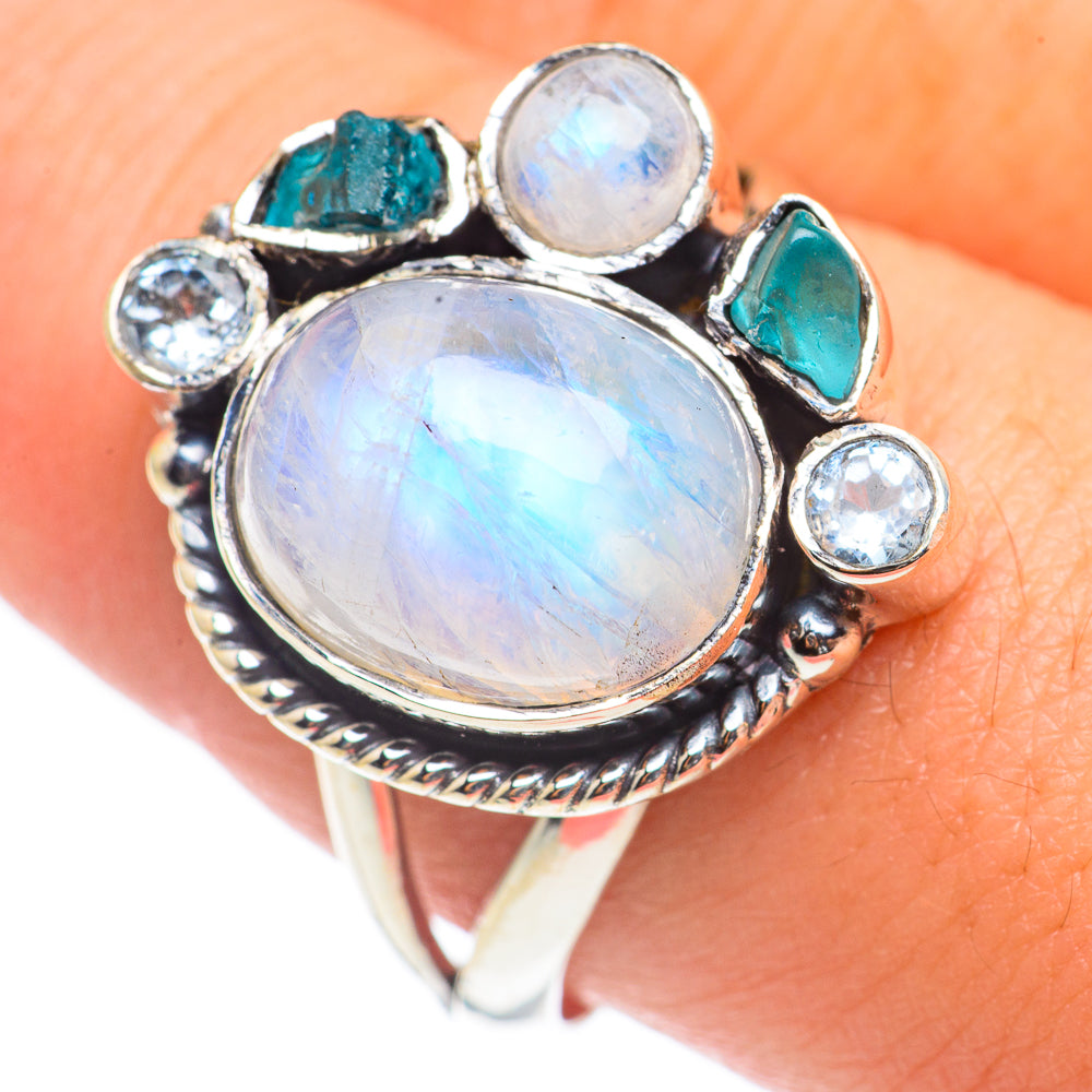 Sterling silver oval gemstone ring with round blue accents and teal side stones