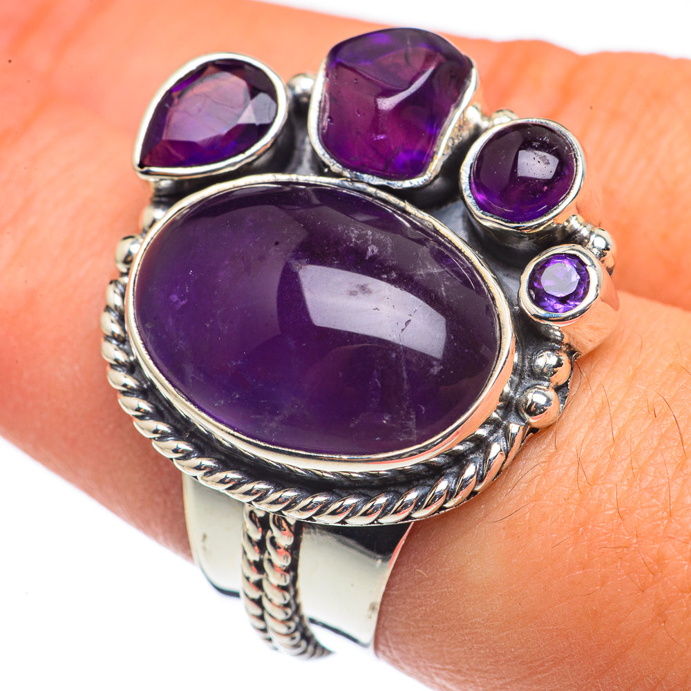 Sterling silver amethyst ring showing large oval center stone, three round side gems