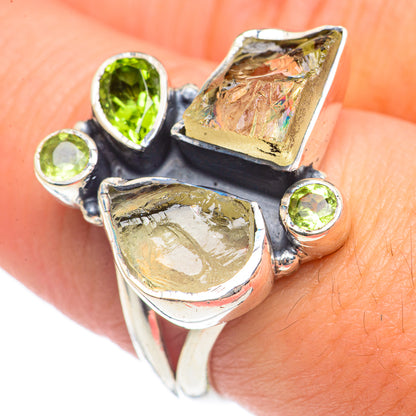925 sterling silver ring with green peridot stones and rough textured gemstone accents.
