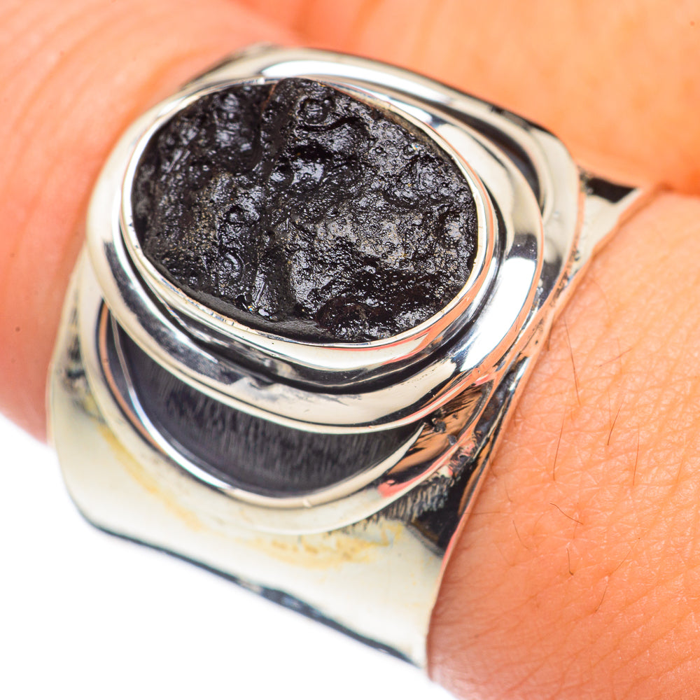 Sterling silver ring with round dark tektite stone, layered bezel on finger