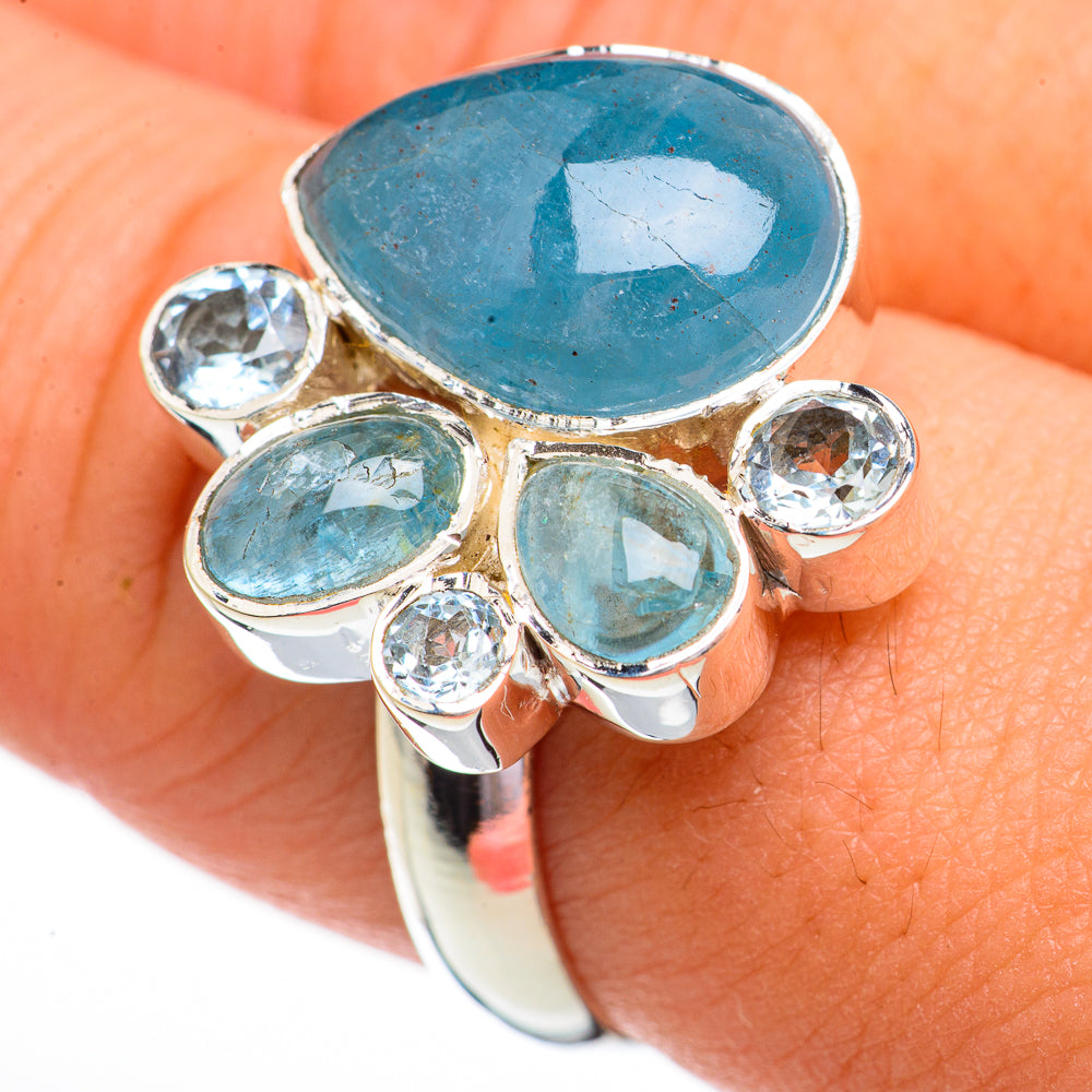 Sterling silver ring with oval aquamarine center and round blue topaz accents