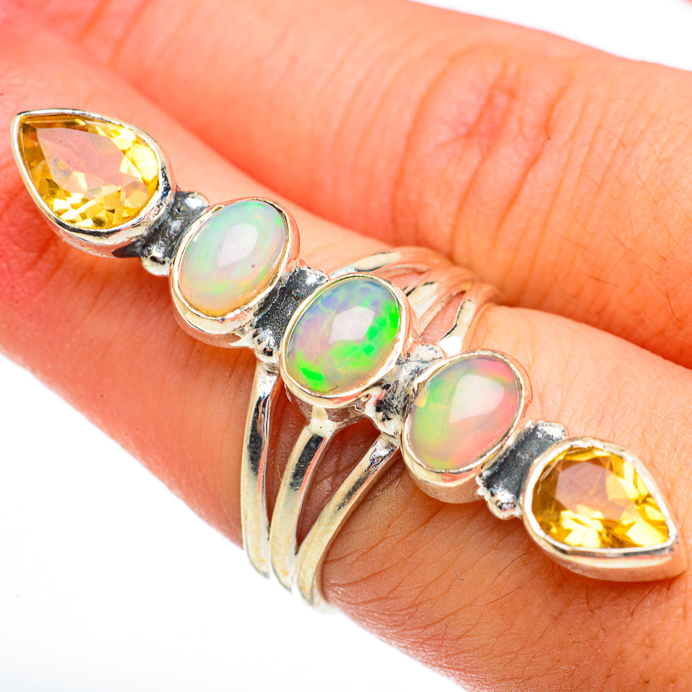 Opal and peridot ring with oval opal and yellow gem accents in silver setting