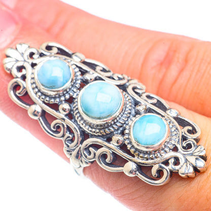 Sterling silver larimar ring on hand with three oval blue cabochon stones