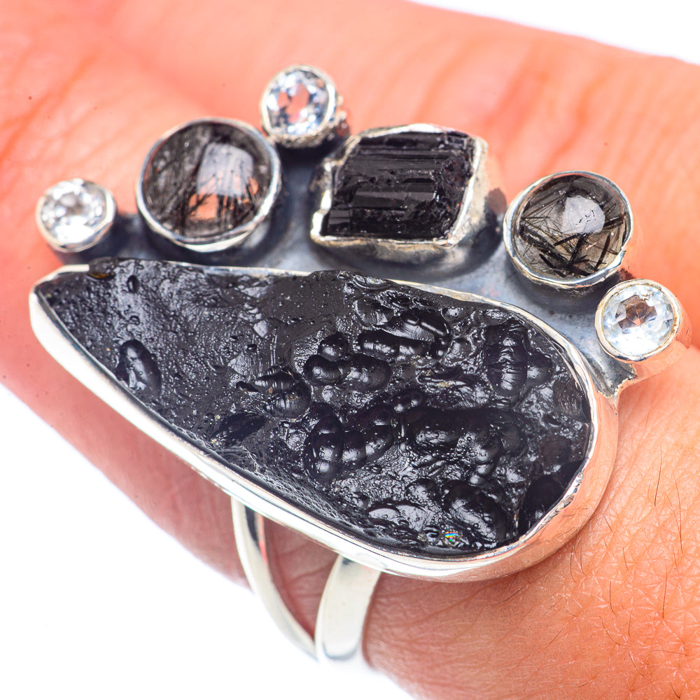 Sterling silver ring with dark tektite-style stone and six round clear gemstone accents