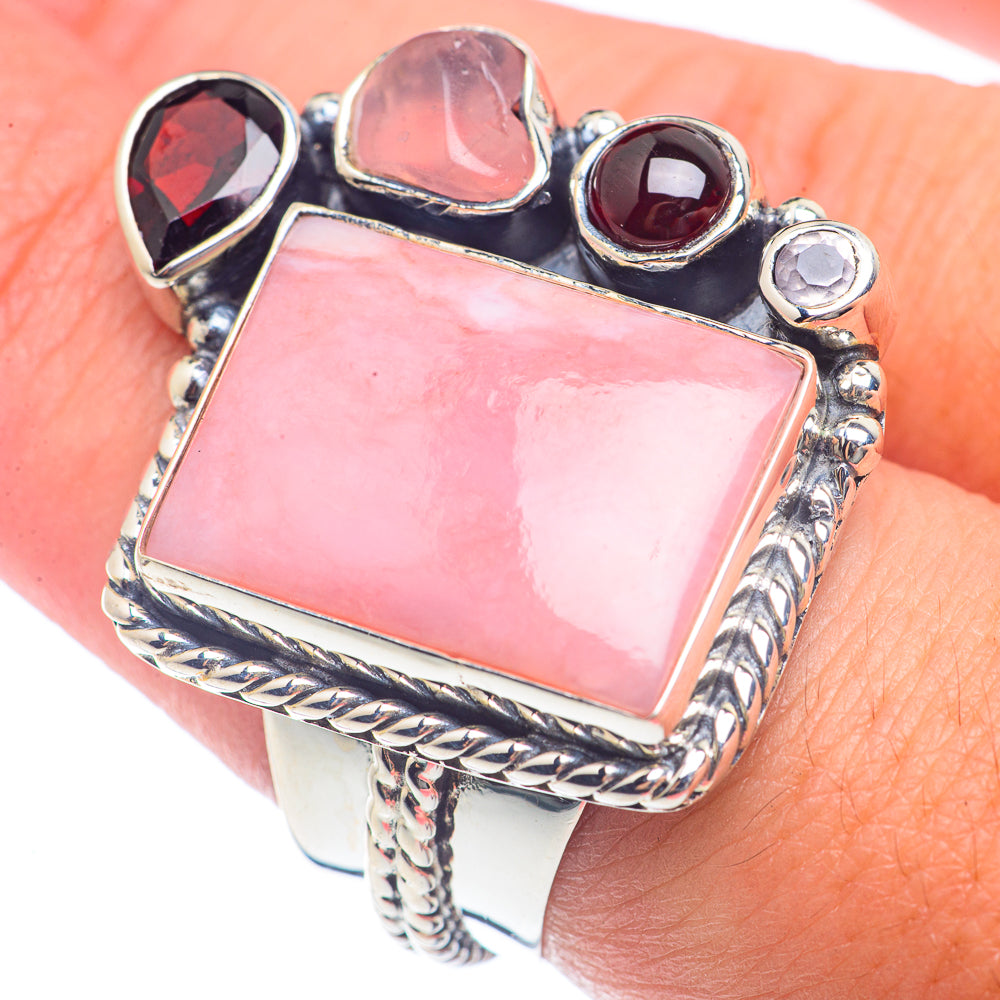 Sterling silver ring with large pink rectangular gemstone and dark red accent stones