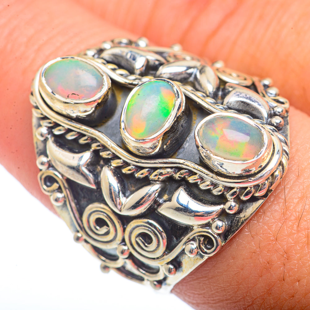 Sterling silver opal ring with three oval iridescent stones and ornate scrollwork