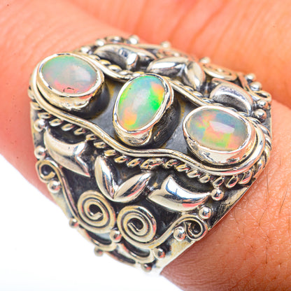 Sterling silver opal ring with three oval iridescent stones and ornate scrollwork