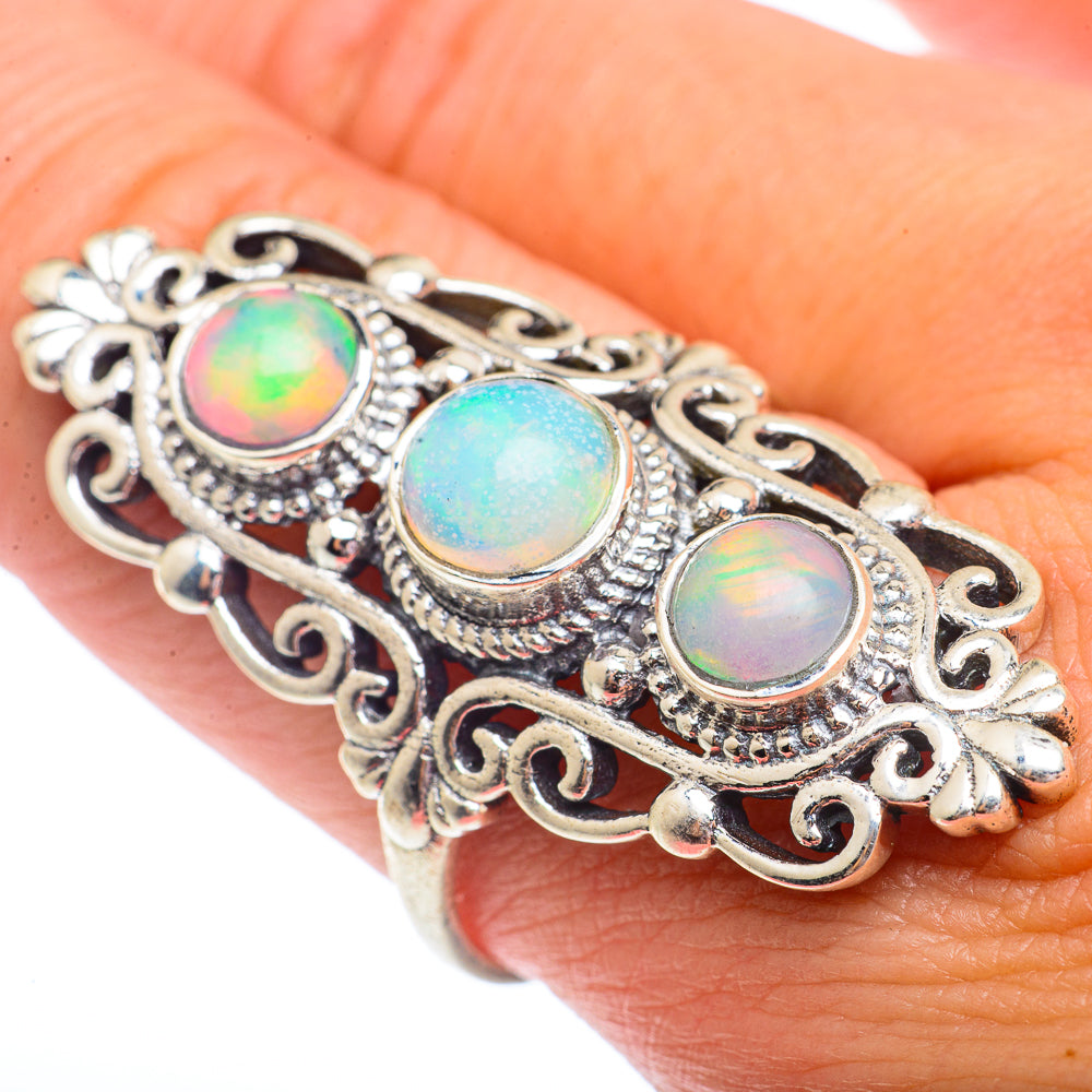 Sterling silver opal ring with three iridescent round gemstones, ornate filigree
