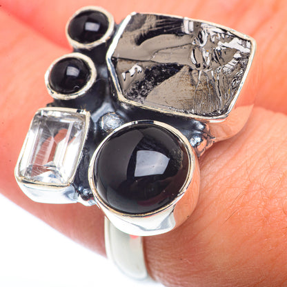 Sterling silver ring showing four stones: black onyx and clear square diamond