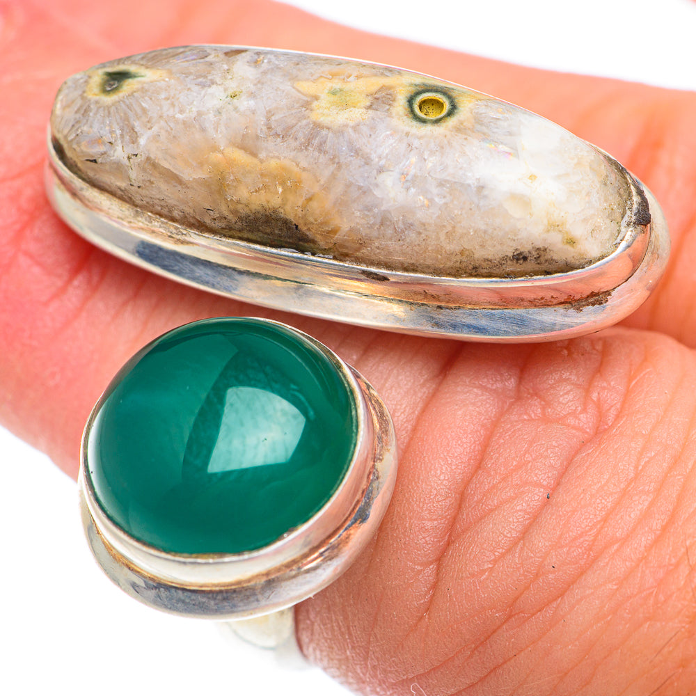 Silver bezel ring with large green oval cabochon, thin band and stone profile view
