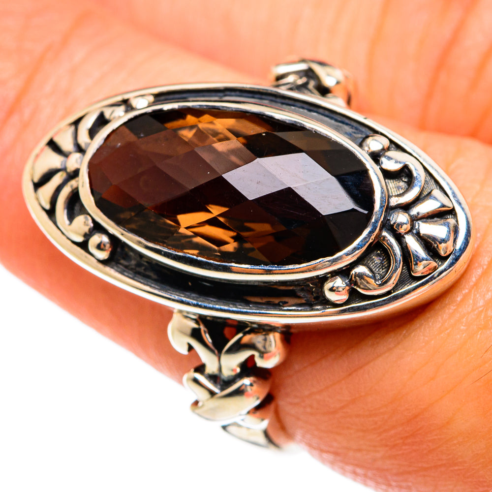 Oval smoky quartz ring in 925 sterling silver with ornate openwork frame and prongs.