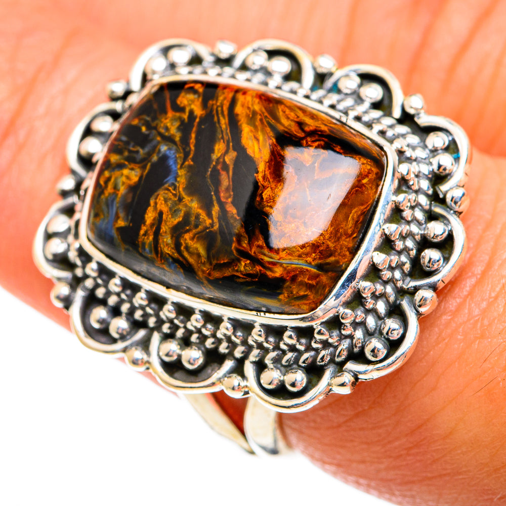 Pietersite ring with rectangular cabochon, silver bead border and wide shank on hand