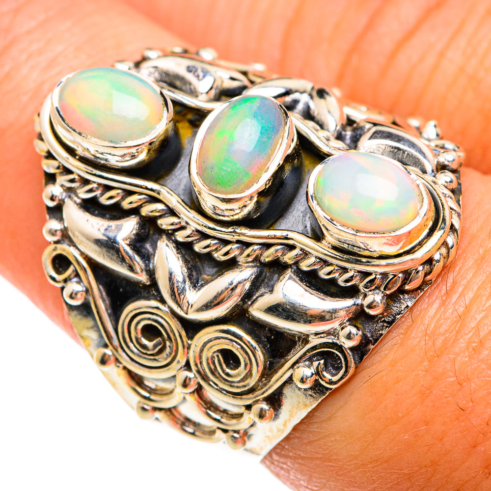 Opal cabochon ring with three round-oval stones and ornate silver filigree band