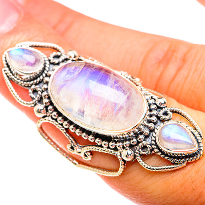 Silver-toned ring with large oval opalescent moonstone and side teardrop stones