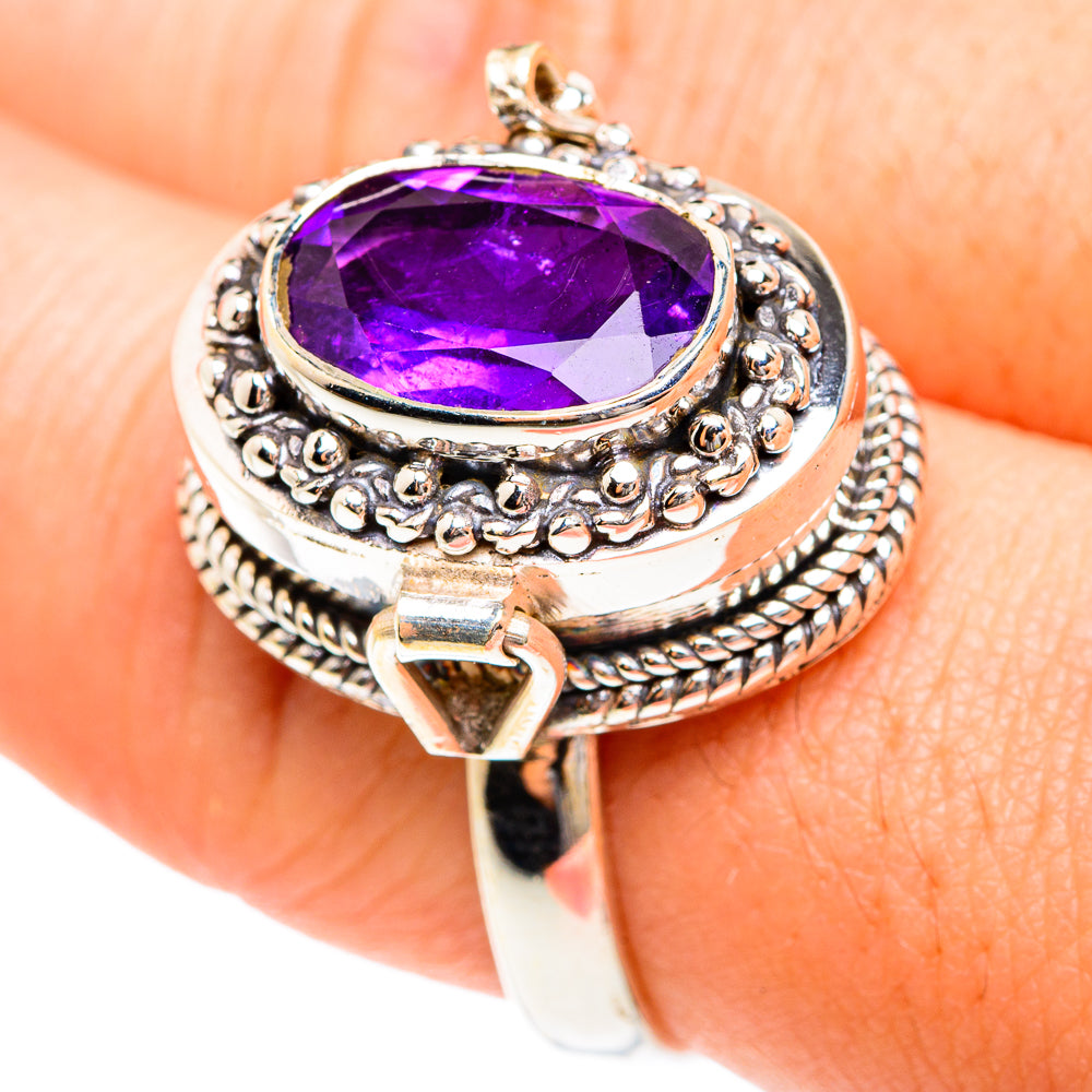 Ornate silver ring with large purple faceted amethyst and raised filigree bezel
