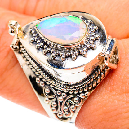 Oval opal-like gemstone ring, bright blue-green iridescence, textured silver border