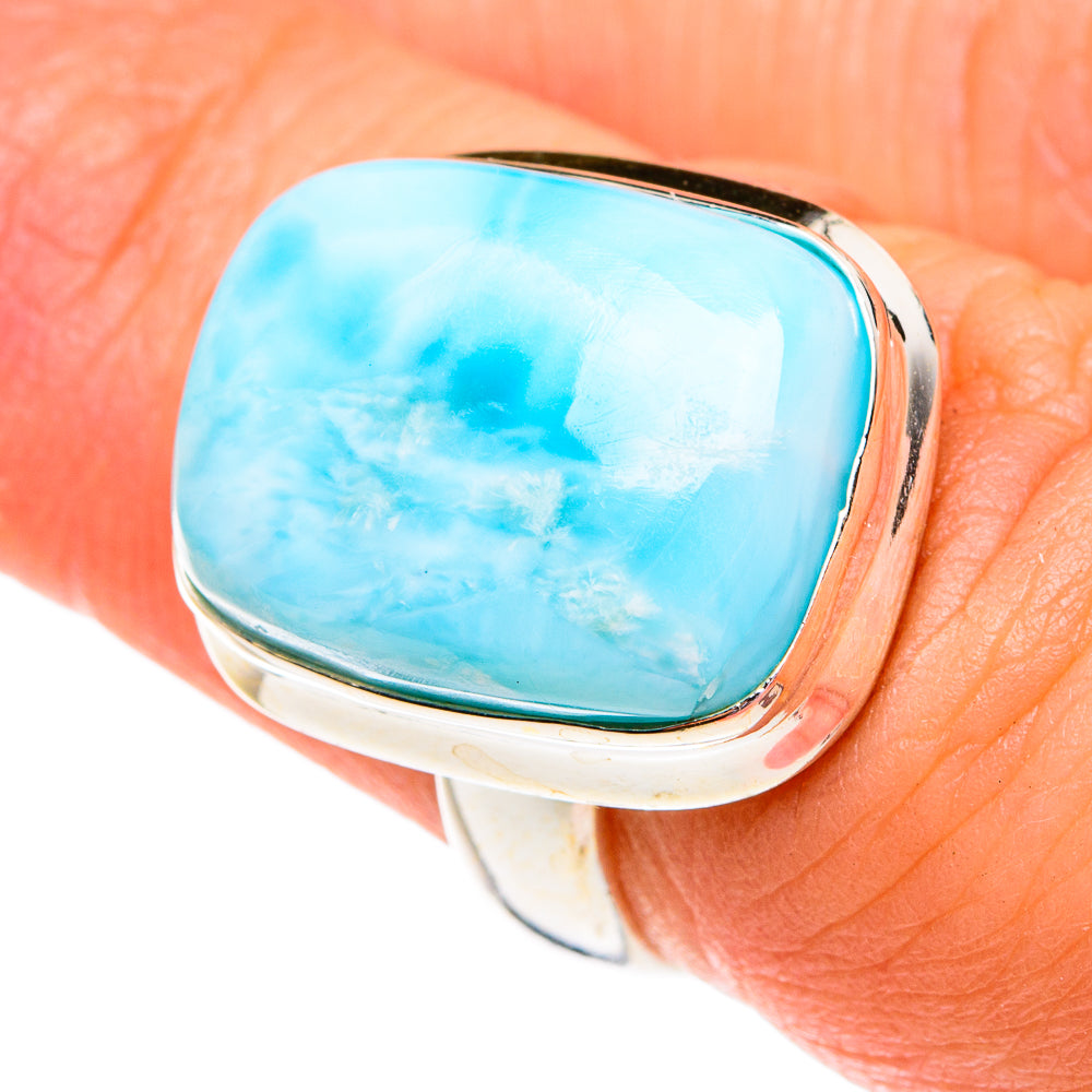 Larimar gemstone ring close-up with oval blue stone in silver bezel on band