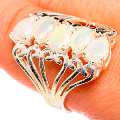 Opal ring showing filigree openwork and three oval faceted stones